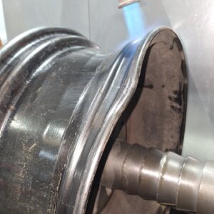 Professional removal of flat spots from alloy wheels using hydraulic straightening at Paint Genie, King's Lynn